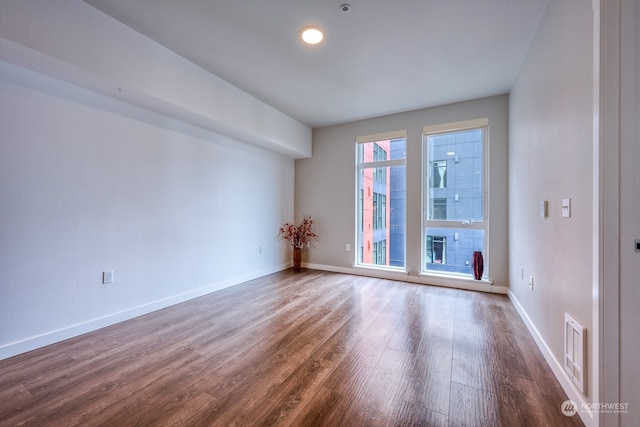 unfurnished room featuring hardwood / wood-style flooring