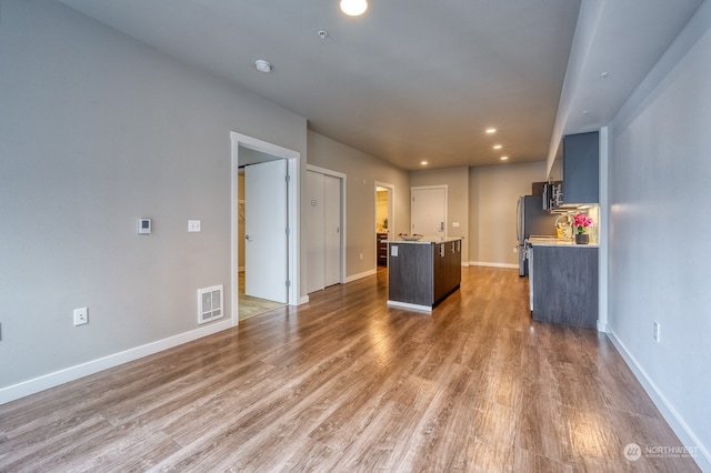 kitchen featuring stainless steel fridge and hardwood / wood-style floors