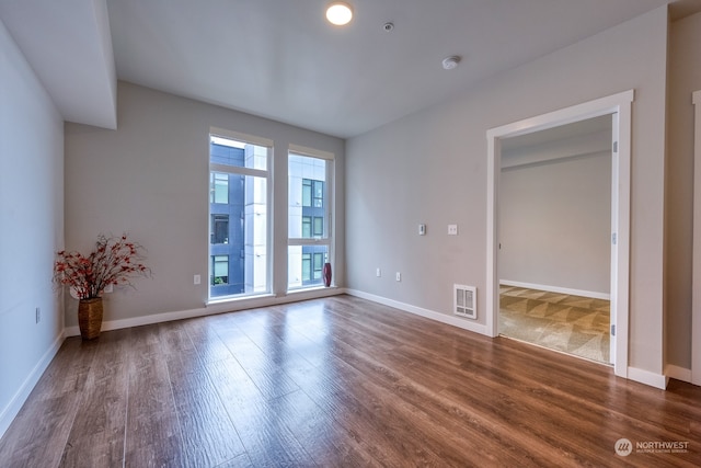 spare room with dark hardwood / wood-style floors