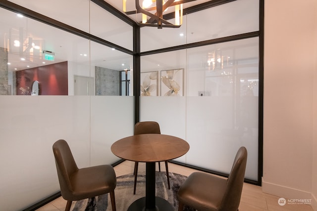 tiled dining room with a chandelier