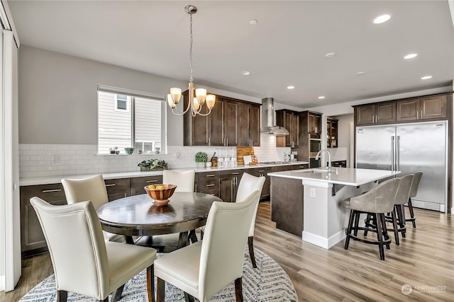 dining room with light wood-style flooring, a chandelier, and recessed lighting