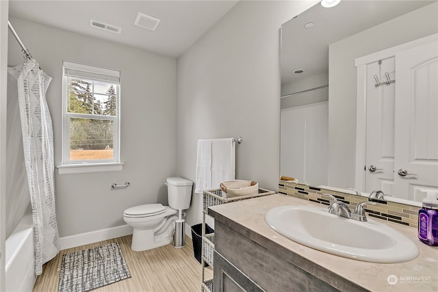 full bathroom featuring shower / bath combination with curtain, tasteful backsplash, vanity, wood-type flooring, and toilet