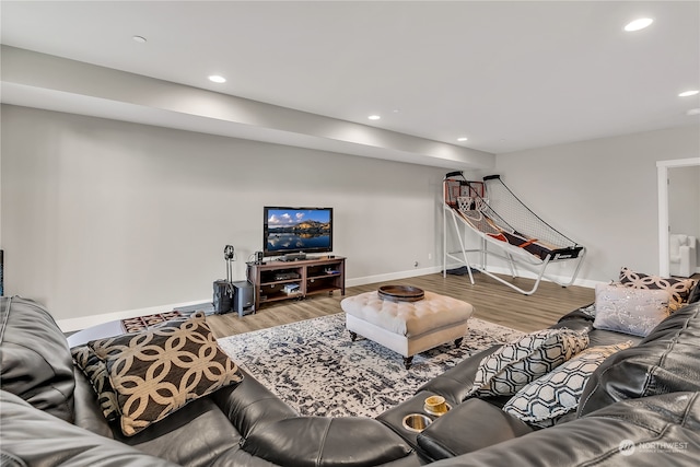 living room with recessed lighting, baseboards, and wood finished floors