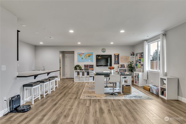 interior space featuring light wood-type flooring, baseboards, and recessed lighting