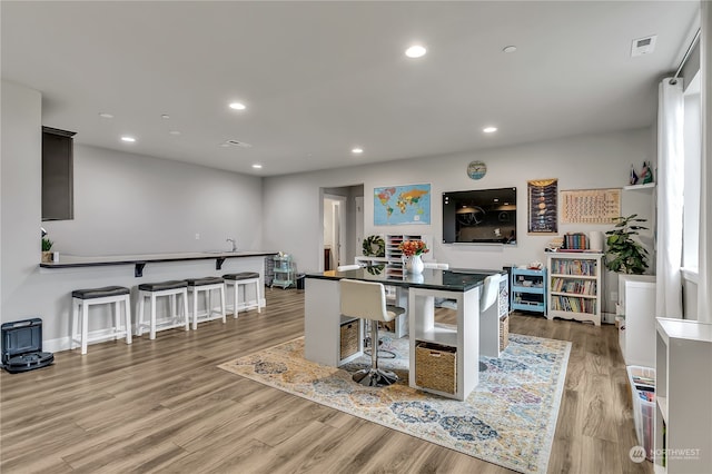 interior space featuring recessed lighting, visible vents, light wood-style flooring, and wine cooler