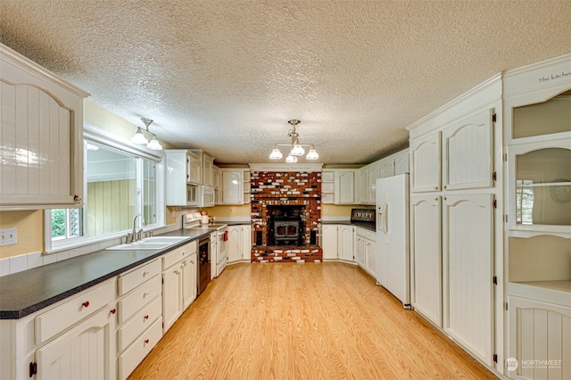 kitchen featuring white cabinets, light wood-type flooring, appliances with stainless steel finishes, and sink