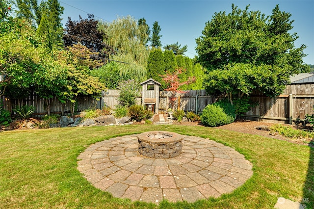 view of yard with a fire pit