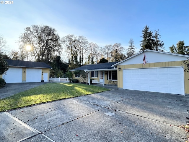 ranch-style home with a garage and a front yard