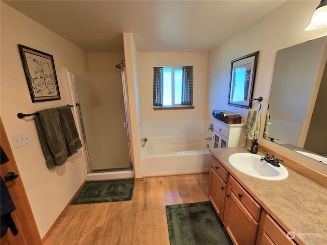 538 Canal Dr NE, Ocean Shores, WA 98569 - full bathroom with a bath, vanity, wood finished floors, and a stall shower