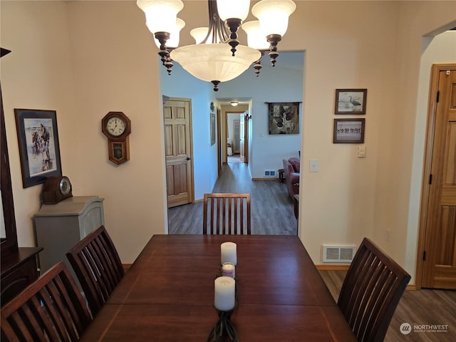538 Canal Dr NE, Ocean Shores, WA 98569 - dining room featuring an inviting chandelier, visible vents, and wood finished floors