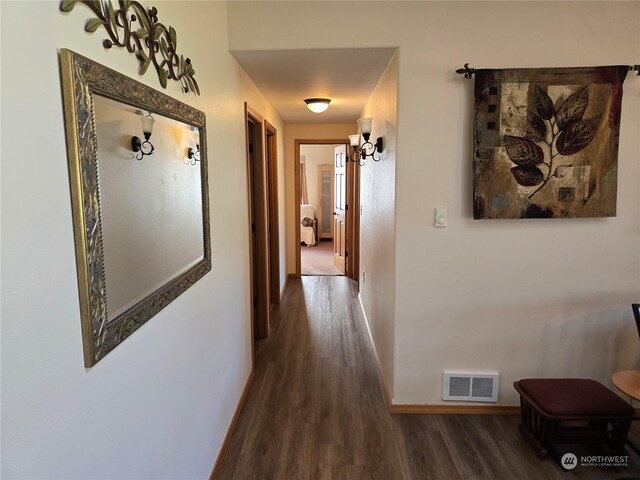 538 Canal Dr NE, Ocean Shores, WA 98569 - corridor featuring dark wood finished floors, visible vents, and baseboards