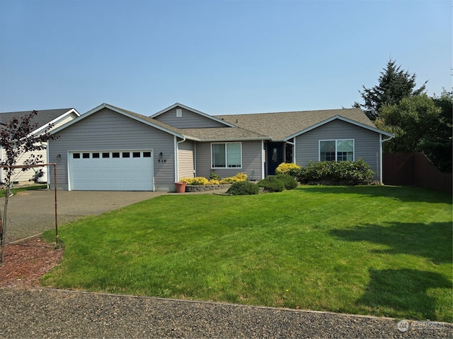 view of front of house featuring a garage and a front lawn