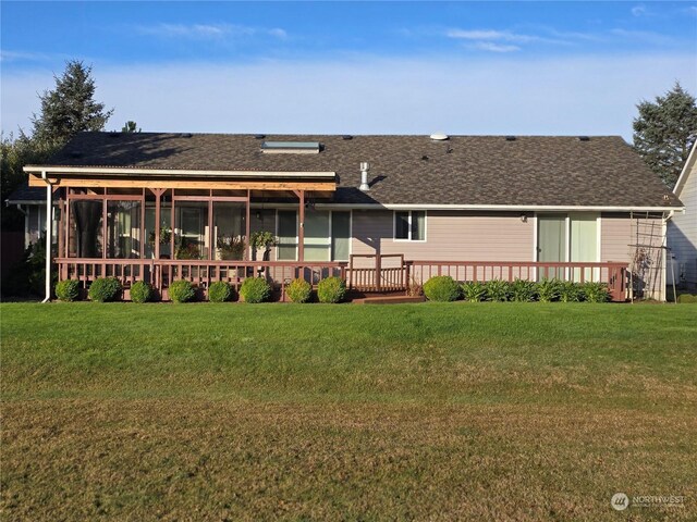 538 Canal Dr NE, Ocean Shores, WA 98569 - back of property featuring a sunroom, a yard, roof with shingles, and a deck