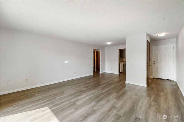116 173rd St S, Spanaway, WA 98387 - unfurnished room featuring a textured ceiling, baseboards, and wood finished floors
