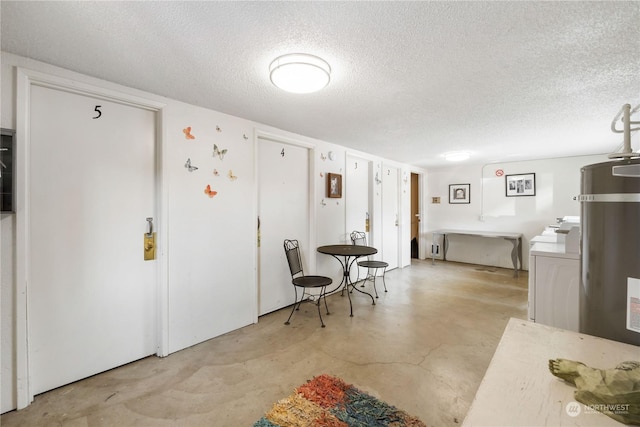 116 173rd St S, Spanaway, WA 98387 - interior space featuring concrete flooring, washer / clothes dryer, a textured ceiling, light countertops, and secured water heater