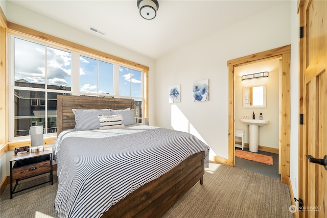 bedroom featuring carpet and ensuite bathroom