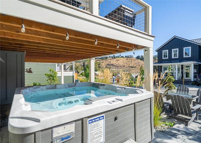 exterior space featuring a mountain view and a hot tub