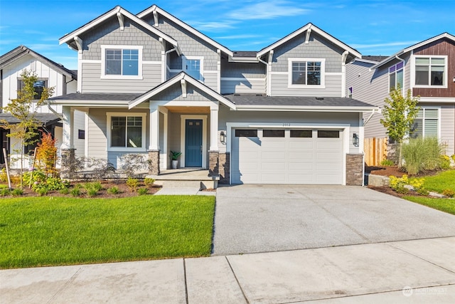 craftsman inspired home featuring a front lawn and a garage