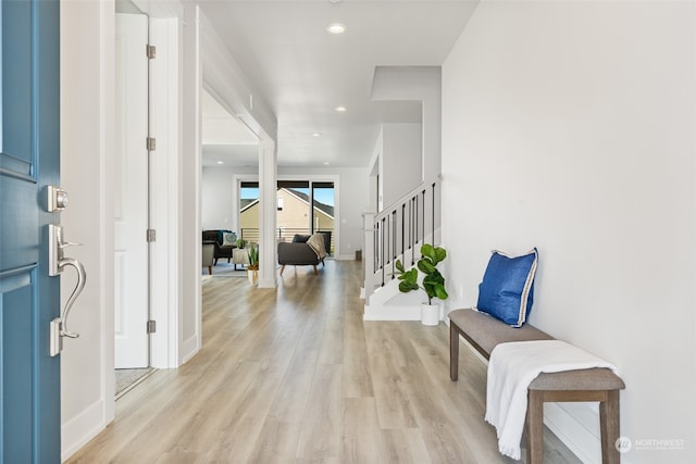 corridor with light hardwood / wood-style flooring