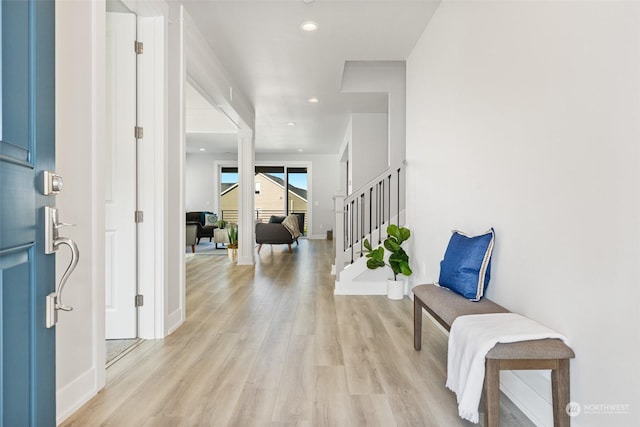 entryway with recessed lighting, stairs, light wood-type flooring, and baseboards