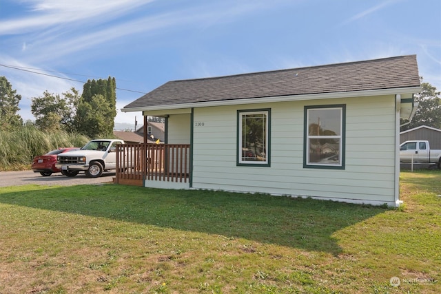 rear view of property with a yard