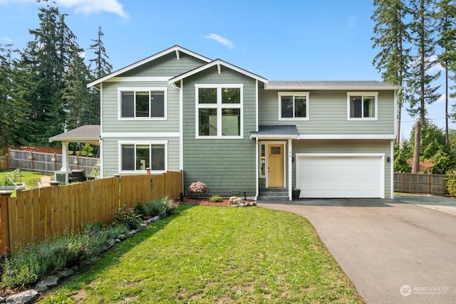 split foyer home with a garage and a front lawn