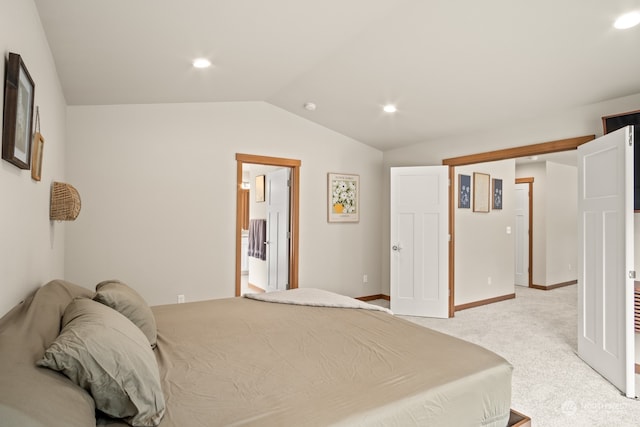 bedroom featuring light colored carpet and vaulted ceiling