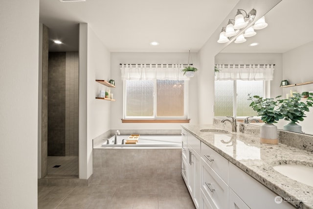 bathroom featuring vanity, independent shower and bath, and tile patterned floors