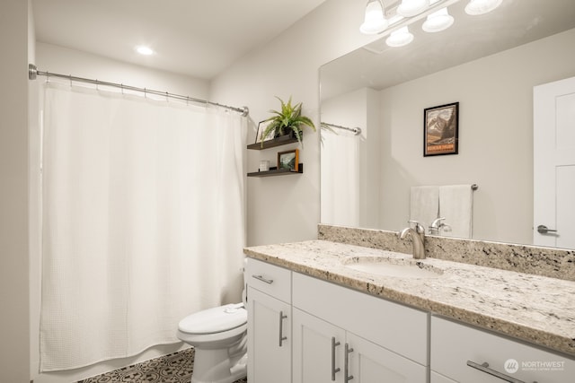 bathroom with vanity, toilet, and walk in shower