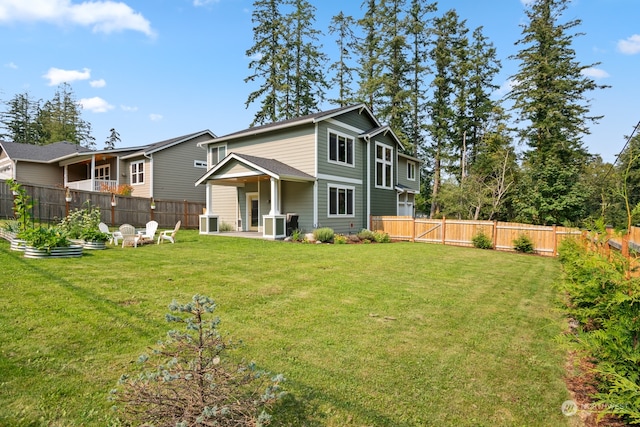 back of house featuring a lawn