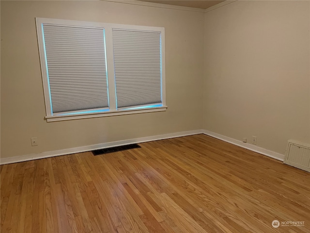 spare room featuring light hardwood / wood-style flooring