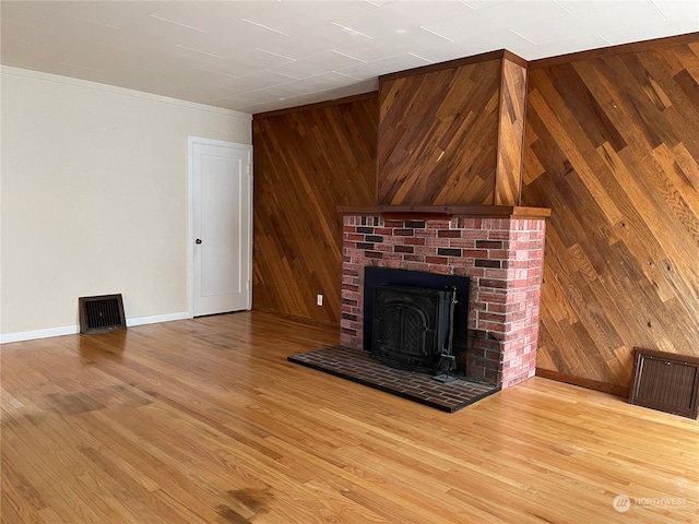 unfurnished living room with wooden walls and hardwood / wood-style floors