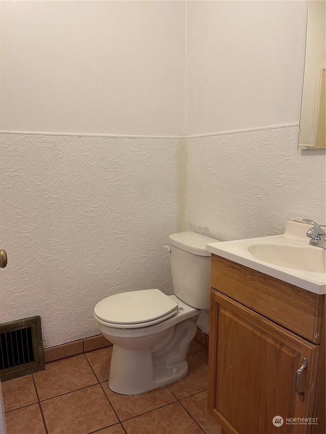 bathroom with vanity, tile patterned flooring, and toilet