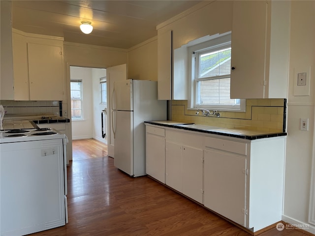 kitchen with decorative backsplash and white cabinets