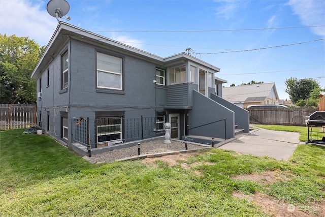 back of property featuring a yard and a patio