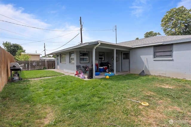 back of house featuring a yard and a patio