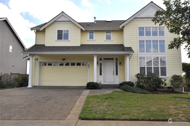 view of front facade featuring a front yard and a garage