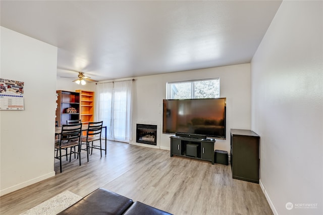 living room with ceiling fan and wood-type flooring