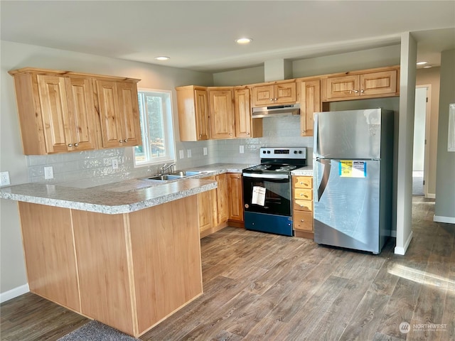 kitchen with stainless steel refrigerator, black range with electric cooktop, sink, and wood-type flooring