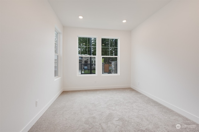 carpeted spare room with recessed lighting and baseboards