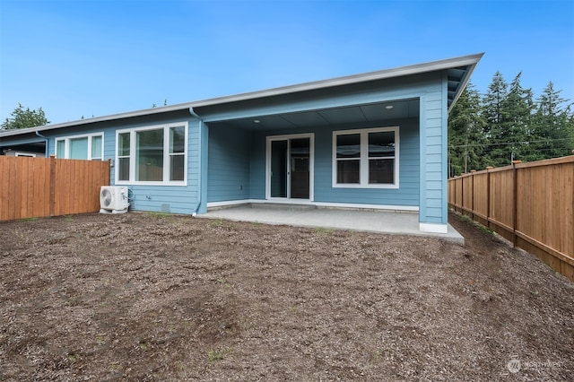 back of house with a patio area and ac unit