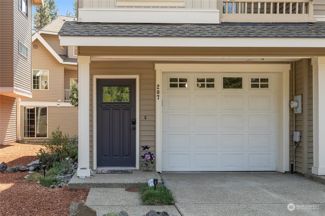 property entrance with a balcony and a garage