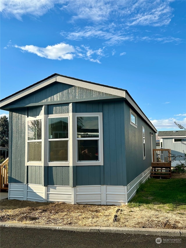 view of side of property with a wooden deck