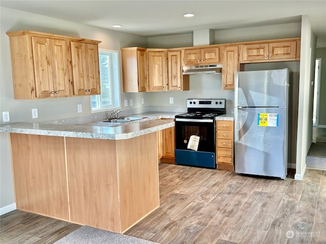 kitchen with stainless steel fridge, electric stove, kitchen peninsula, light wood-type flooring, and light brown cabinetry