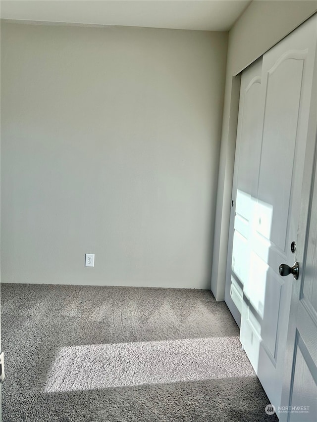 unfurnished bedroom featuring a closet and carpet floors