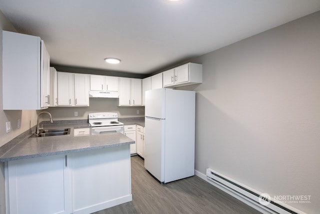 kitchen with white appliances, kitchen peninsula, hardwood / wood-style flooring, baseboard heating, and white cabinets