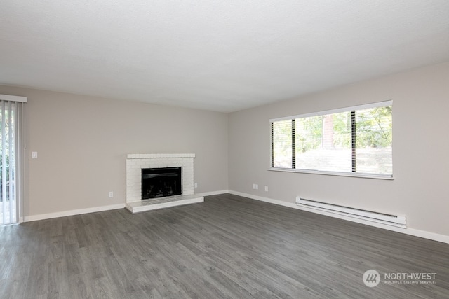 unfurnished living room with a fireplace, dark hardwood / wood-style flooring, a healthy amount of sunlight, and a baseboard radiator