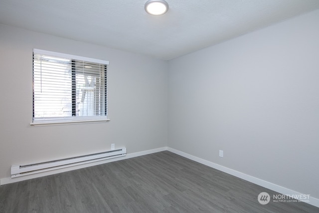 empty room featuring a textured ceiling, a baseboard radiator, and dark wood-type flooring