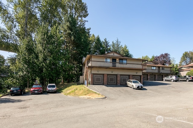 view of front of house featuring a balcony and a garage