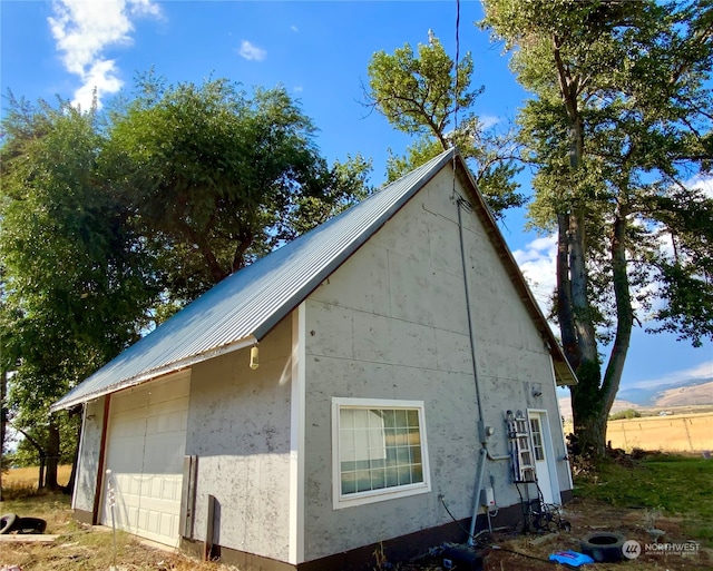 view of home's exterior with an outbuilding and a garage